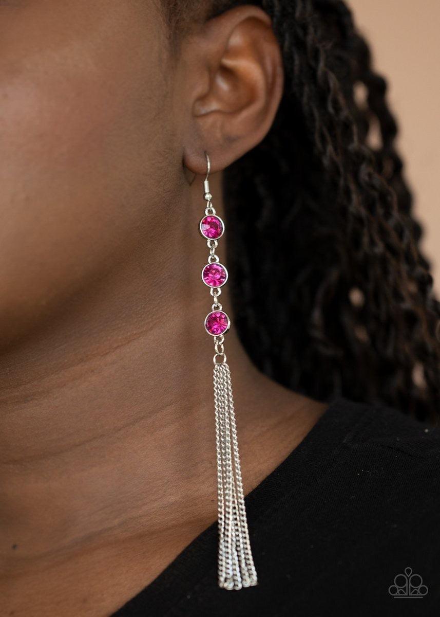 Paparazzi Accessories Moved To Tiers - Pink A shimmery silver chain tassel swings from the bottom stack of three glittery pink rhinestones, creating a fabulously tiered look. Earring attaches to a standard fishhook fitting. Sold as one pair of earrings. J