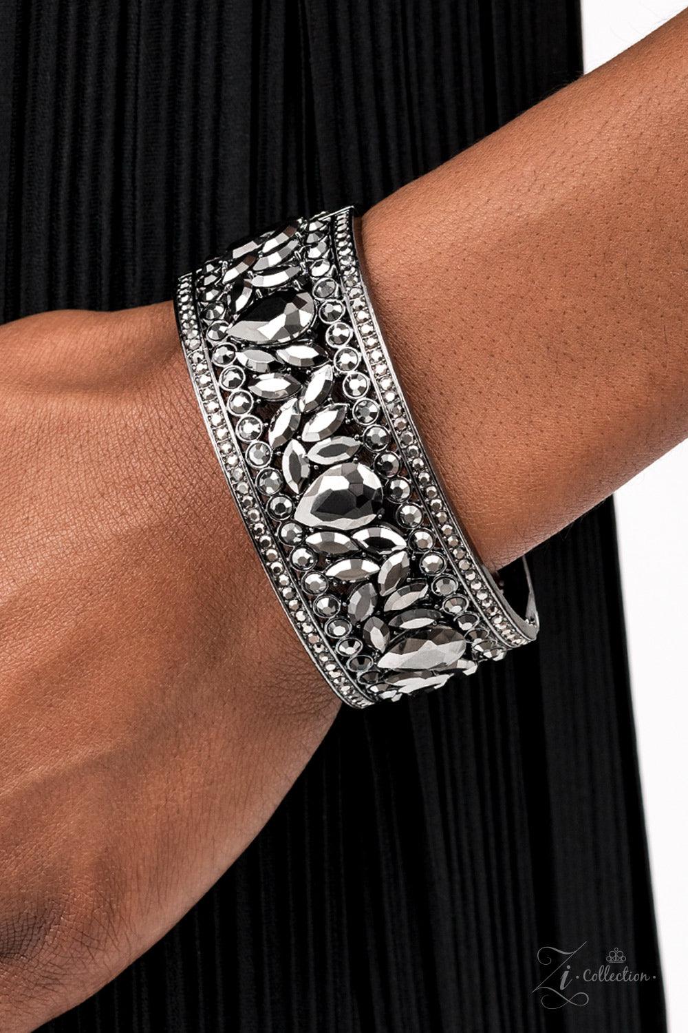 Paparazzi Accessories After Party Powerhouse: ZiCollection A smoldering collection of oversized teardrop and marquise cut hematite rhinestones haphazardly coalesce between linear stacked rows of round hematite rhinestones. The dazzling hematite spangled g