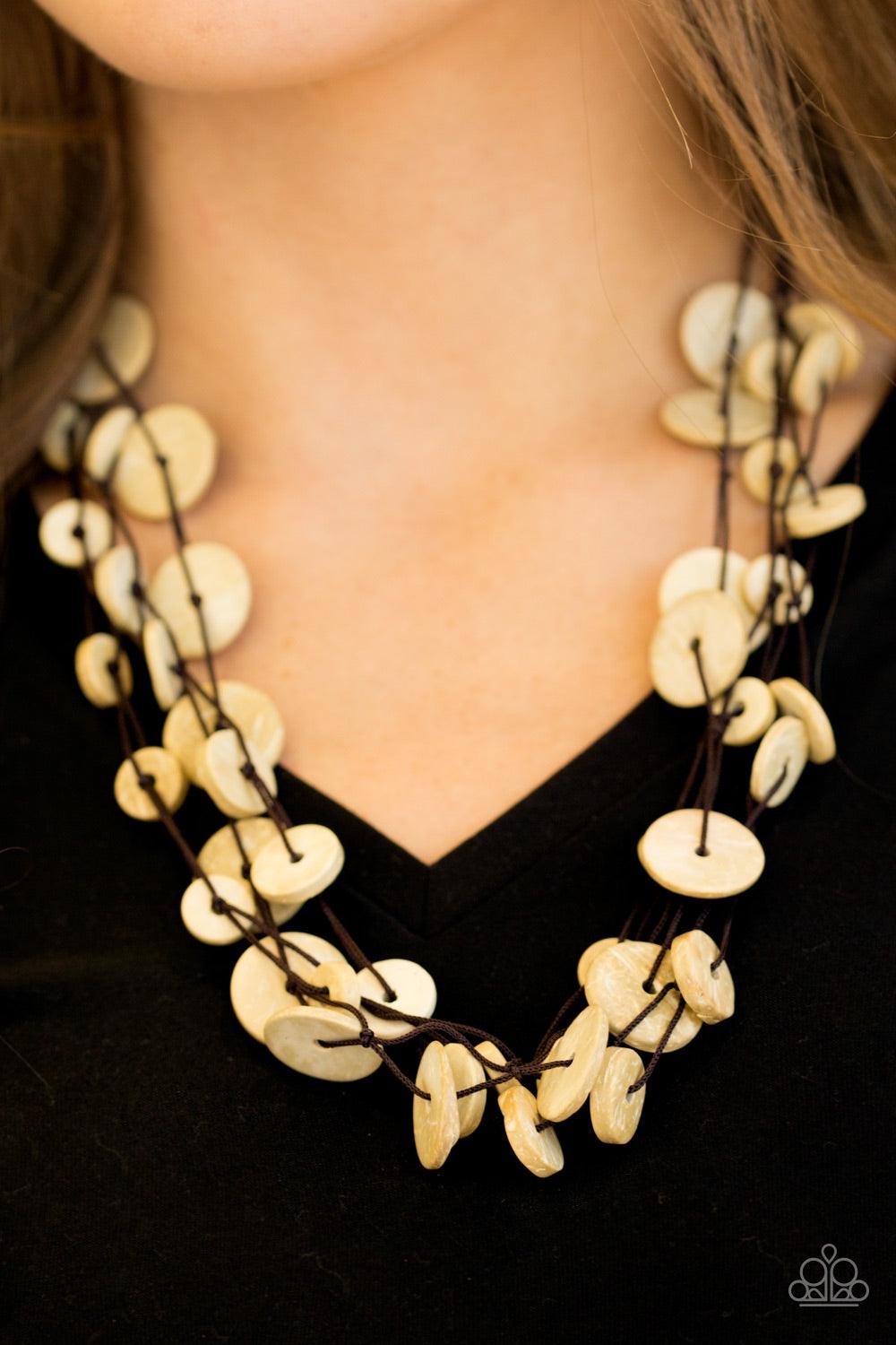 Paparazzi Accessories Bermuda Beach House - White Tinted in a neutral white finish, distressed wooden discs trickle along strands of knotted brown cording, creating colorful layers below the collar for a seasonal vibe. Features a button-loop closure. Jewe