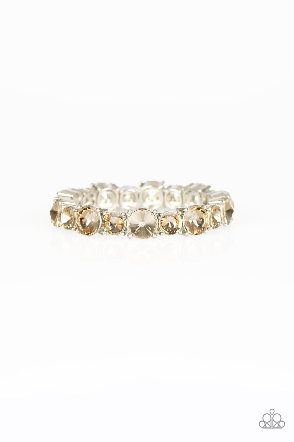 Paparazzi Accessories Born To Bedazzle - Brown An assortment of oversized golden topaz rhinestones are pressed into sleek square frames and threaded along stretchy bands, creating a blinding sparkle around the wrist. Jewelry