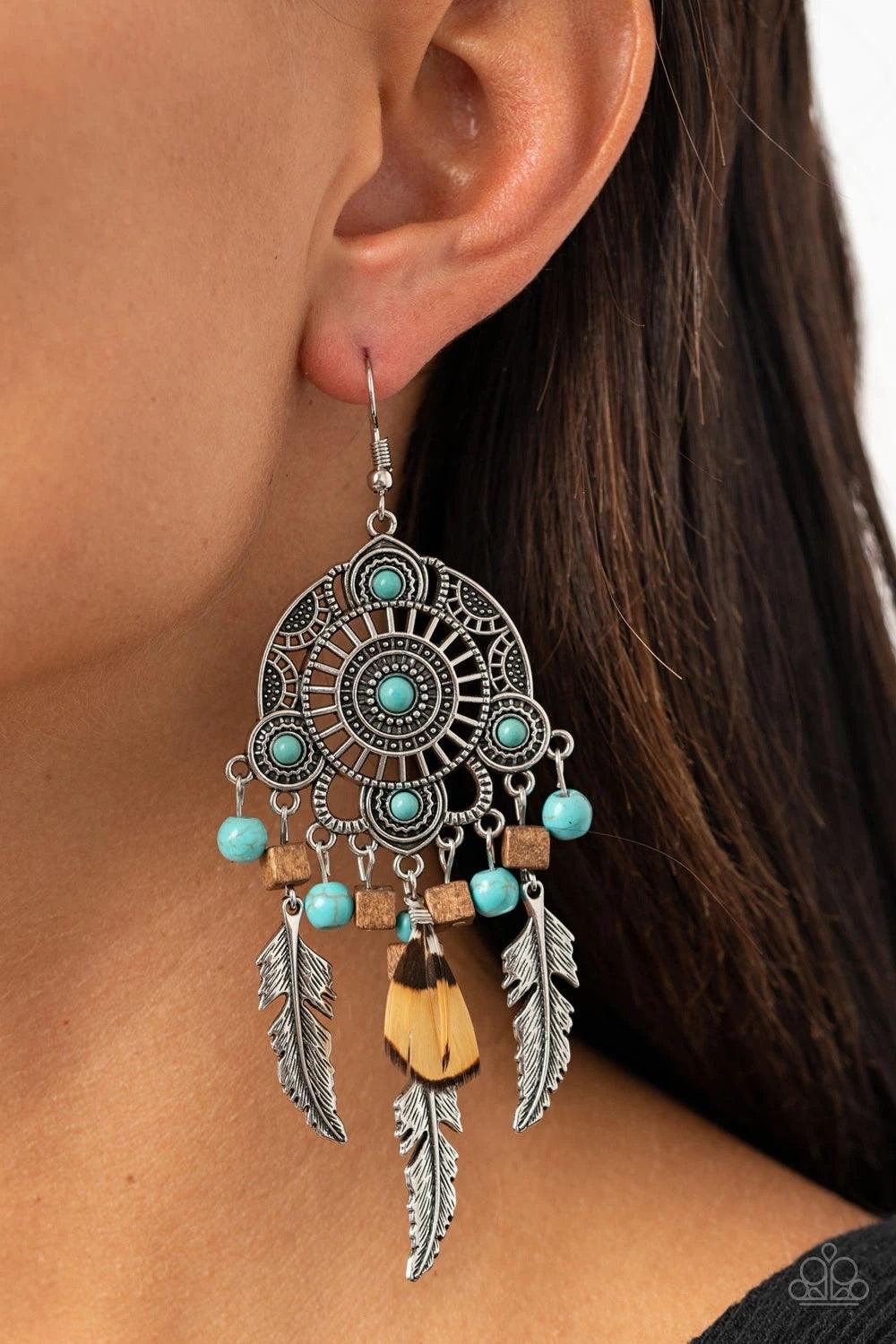 Paparazzi Accessories Desert Plains - Blue Radiating with studded patterns, a turquoise stone dotted silver frame gives way to a whimsical collection of silver feather charms, wooden cube beads, refreshing turquoise stones, and a brown feather, creating a