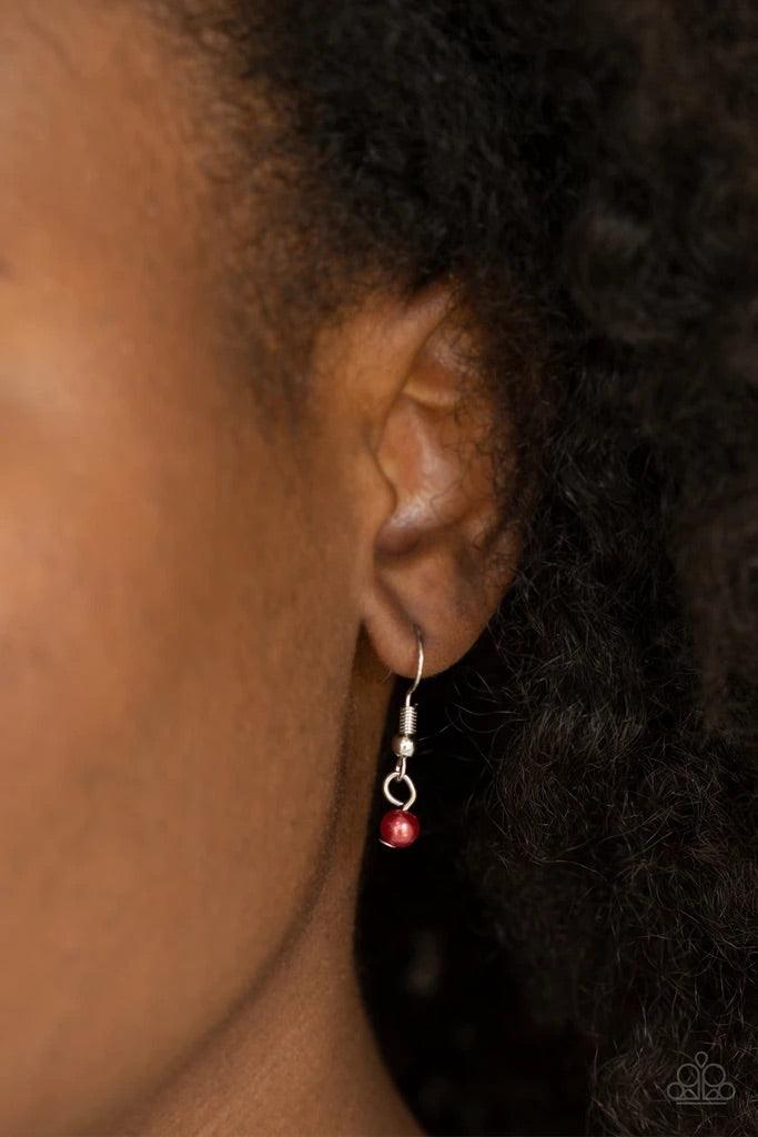Paparazzi Accessories Romeo Romance - Red Infused with dainty red pearls and a shimmery silver heart charm, a stenciled silver heart pendant swings from the bottom of a lengthened silver chain for a whimsical look. Features an adjustable clasp closure. So