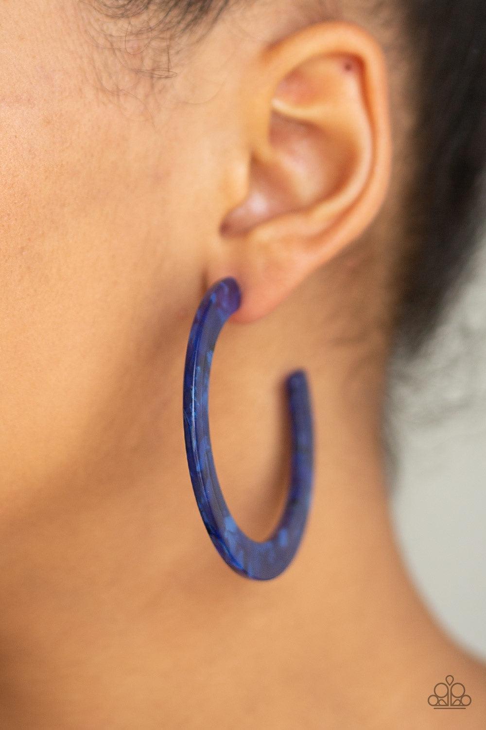 Paparazzi Accessories HAUTE Tamale - Blue Featuring a faux-marble finish, a blue acrylic hoop curls around the ear for a retro-radiant look. Earring attaches to a standard post fitting. Hoop measures approximately 2 1/4" in diameter. Jewelry