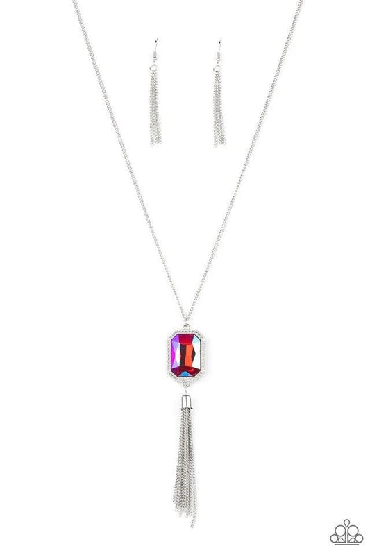Paparazzi Accessories Blissed Out Opulence - Pink An impressive pink emerald cut gem is pressed into the center of a silver studded frame, creating an ethereal pop of color at the bottom of a lengthened silver chain. A silver chain tassel swings from the