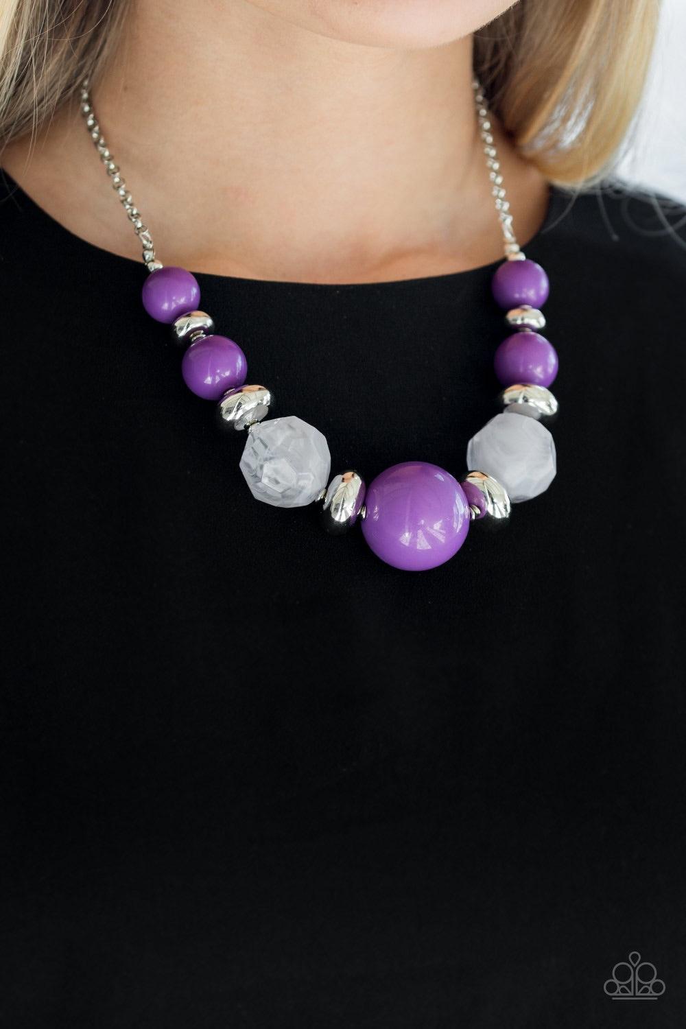Paparazzi Accessories Daytime Drama - Purple Gradually increasing in size near the center, a collection of purple, silver, and cloudy beads join below the collar in a statement making fashion. Features an adjustable clasp closure. Jewelry