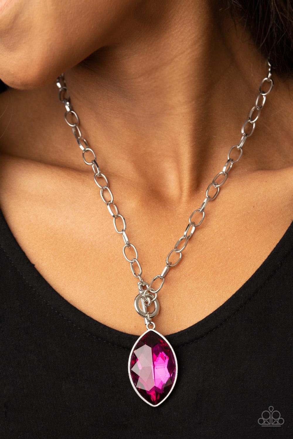 Paparazzi Accessories Unlimited Sparkle ~Pink Featuring a regal marquise style cut, a dramatically oversized Pink Peacock rhinestone swings from a chunky silver chain, creating a gorgeous pendant below the collar. Features a toggle closure. Sold as one in