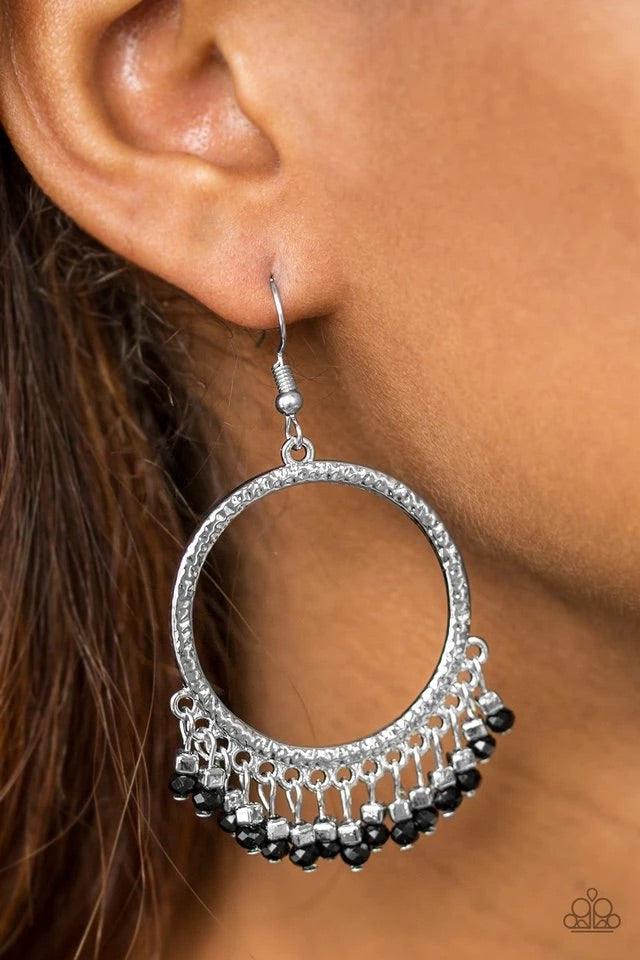 Paparazzi Accessories Tambourine Tango - Black Faceted black beads and silver cube beads swing from the bottom of a hammered silver hoop, creating a flirty fringe. Earring attaches to a standard fishhook fitting. Sold as one pair of earrings. Paparazzi Je