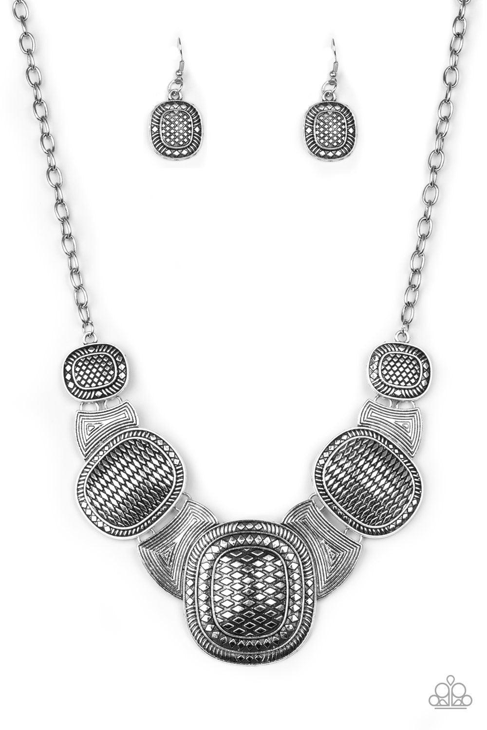 Paparazzi Accessories Prehistoric Powerhouse - Silver Radiating with geometric and linear details, ornate silver plates link below the collar for a bold tribal look. Features an adjustable clasp closure. Jewelry