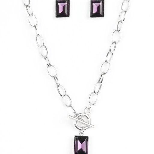Paparazzi Accessories Wear It Like You Mean It! ~Purple Featuring a regal emerald-style cut, a glassy purple rhinestone is pressed into a sleek silver frame. The glittery frame swings from the bottom of a bold silver chain, creating a glamorous pendant be