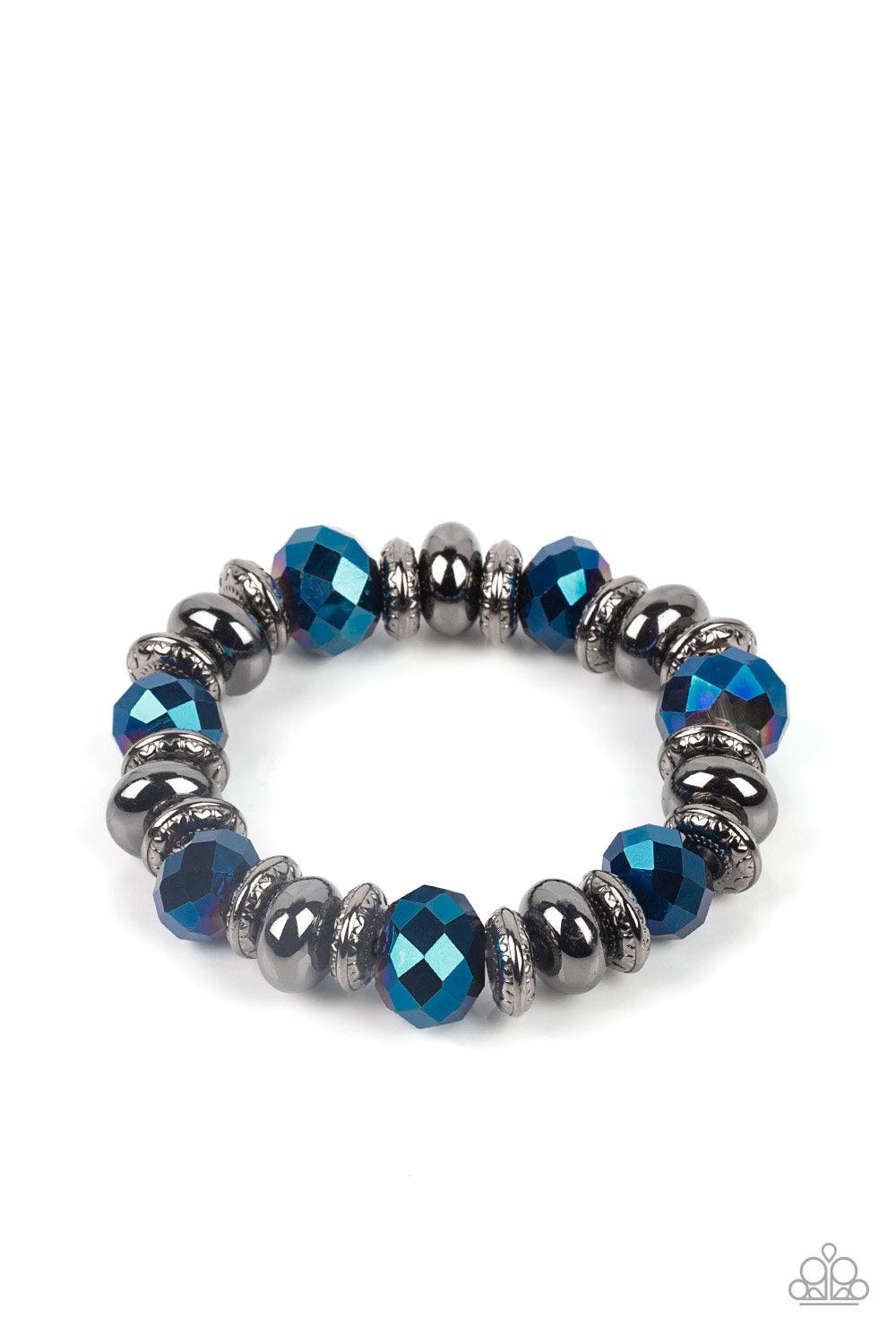 Paparazzi Accessories Power Pose - Blue An oversized assortment of textured gunmetal rings, smooth gunmetal beads, and metallic blue crystal-like beads are threaded along stretchy bands around the wrist for a glitzy finish. Sold as one individual bracelet