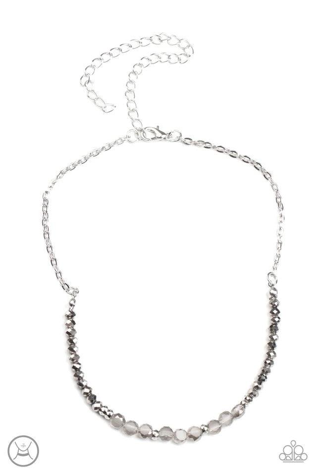 Paparazzi Accessories Space Odyssey - Silver A dainty collection of mismatched silver beads, hematite rhinestones, and smoky crystal-like accents are threaded along an invisible wire around the neck for a stellar look. Features an adjustable clasp closure