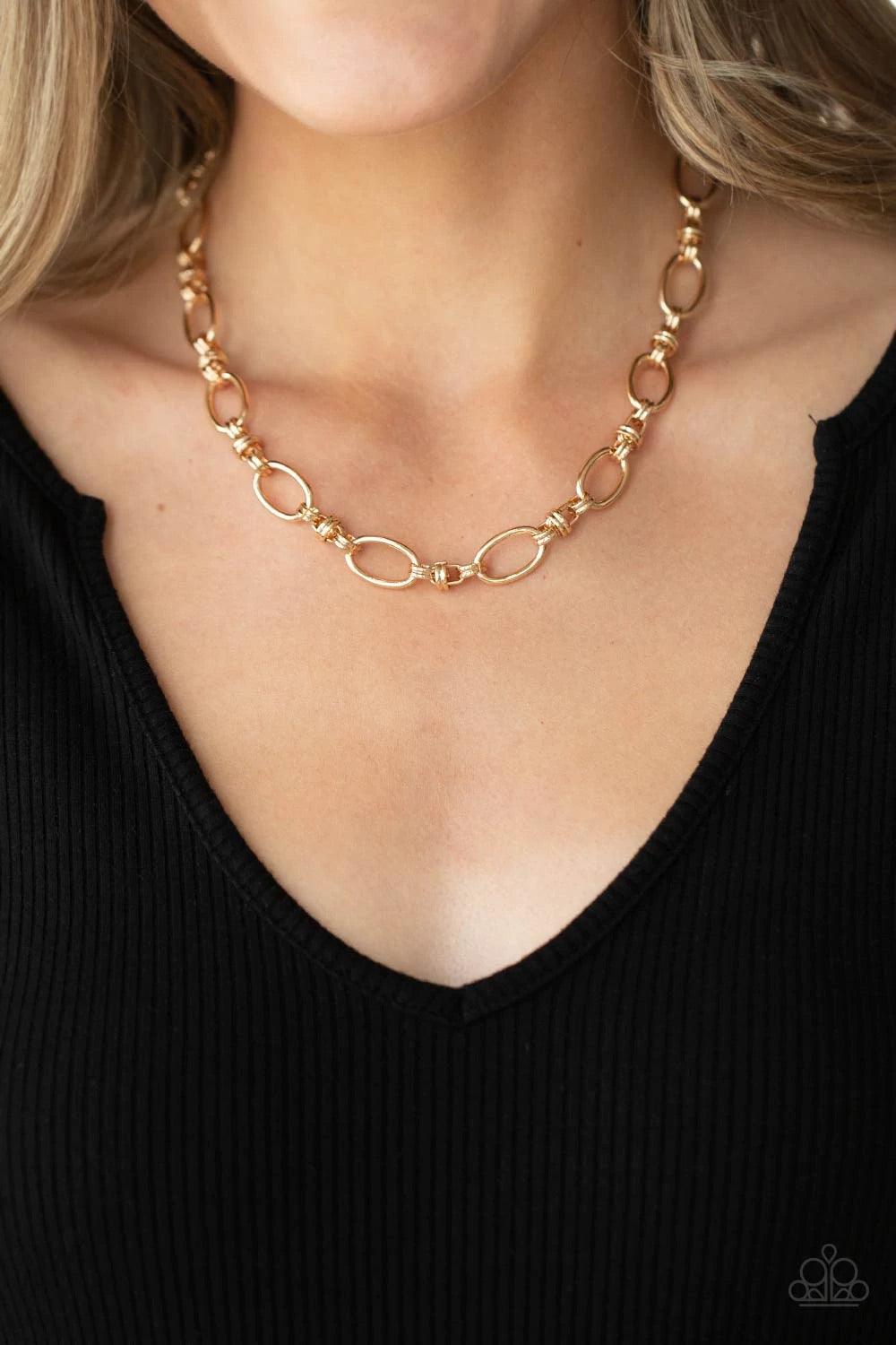 Paparazzi Accessories Defined Drama - Gold Pairs of joined gold links connect a collection of gold oval frames below the collar, creating an edgy chain. Features an adjustable clasp closure. Sold as one individual necklace. Includes one pair of matching e