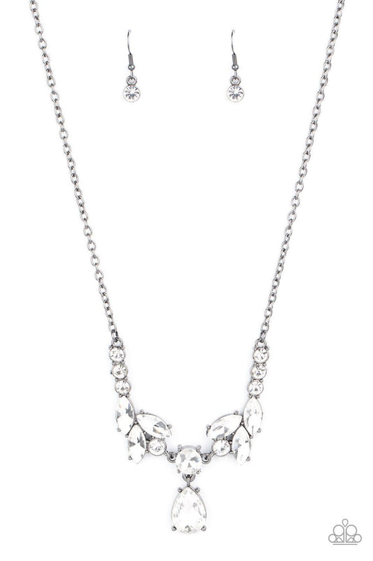 Paparazzi Accessories Unrivaled Sparkle - Black Tiers of white rhinestone encrusted frames delicately link below the collar, giving way to an oversized white teardrop rhinestone pendant for a timeless finish. Features an adjustable clasp closure. Sold as