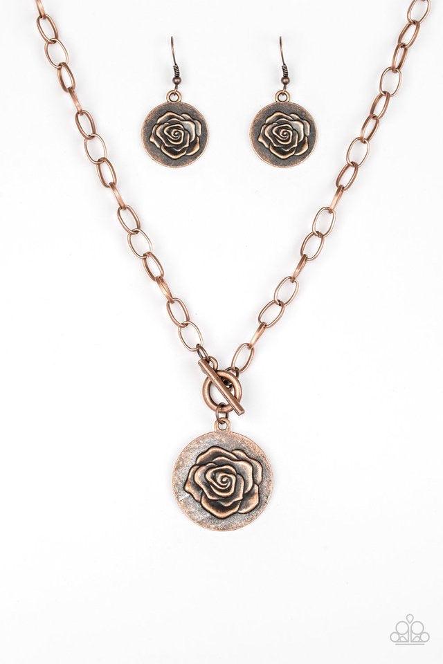 Paparazzi Accessories Beautifully Belle - Copper Embossed in a whimsical rosebud pattern, a shimmery copper frame swings below the collar for a casual look. Features a toggle closure. Sold as one individual necklace. Includes one pair of matching earrings