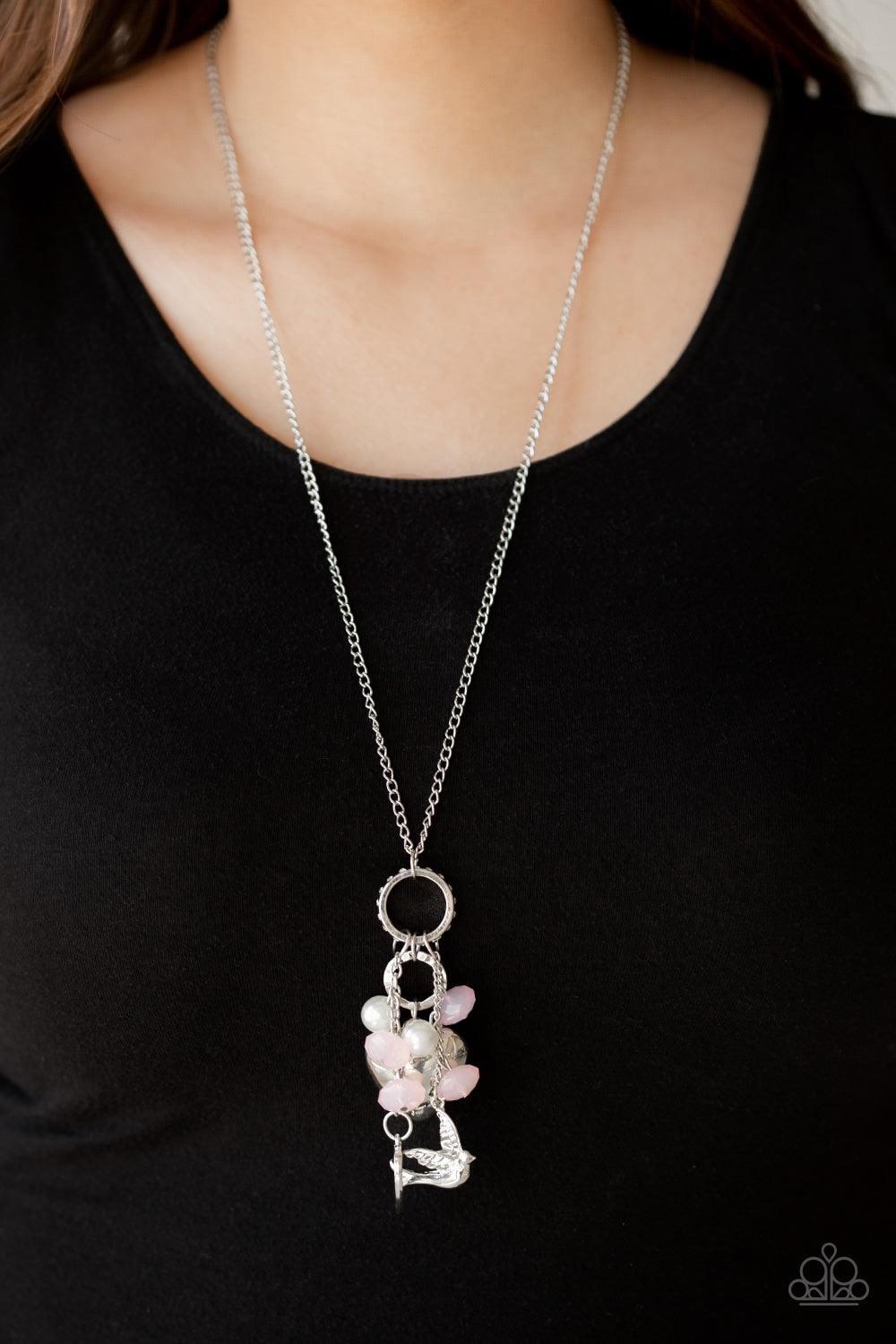 Paparazzi Accessories I Will Fly - Pink A silver bird charm, silver heart charms, and collection of white pearls and opaque pink crystal-like beads swing from the bottom of a lengthened silver chain for a whimsically clustered look. Features an adjustable
