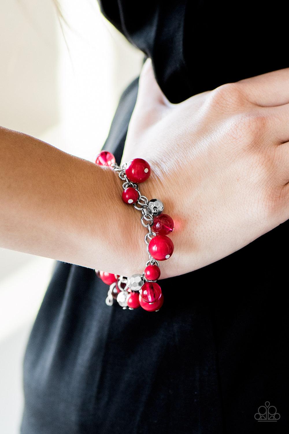 Paparazzi Accessories WANDERLUST For Life ~Red Polished and opaque red beading trickle from a shimmery silver chain, creating a colorful fringe around the wrist. Faceted silver beads are sprinkled between the colorful accents for a whimsical finish. Featu