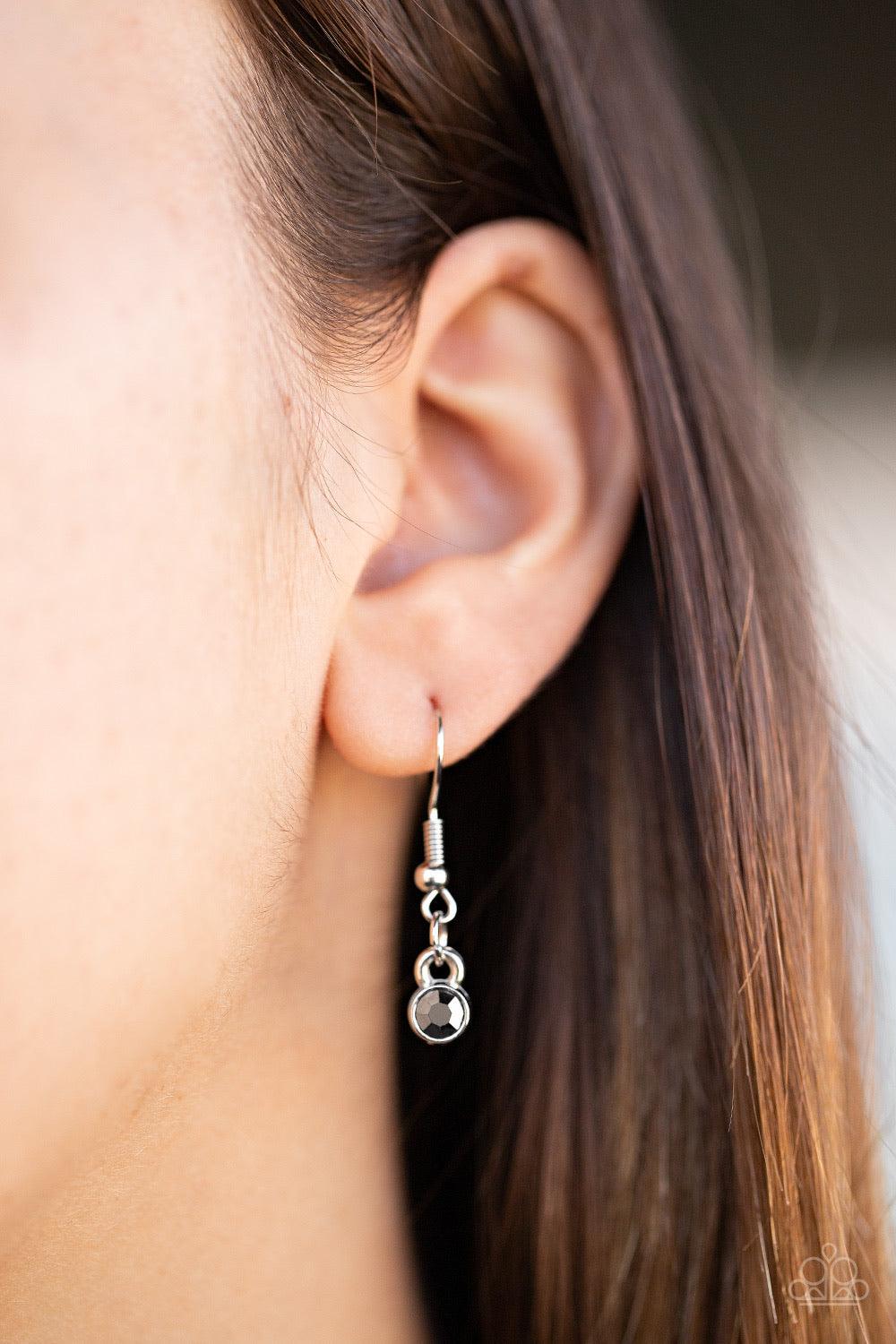 Paparazzi Accessories Constellation Collection - Silver Varying in shape and size, triangular, round, and square cut hematite and smoky rhinestones coalesce into a floating pendant at the bottom of doubled silver chains, creating a stellar shimmer below t