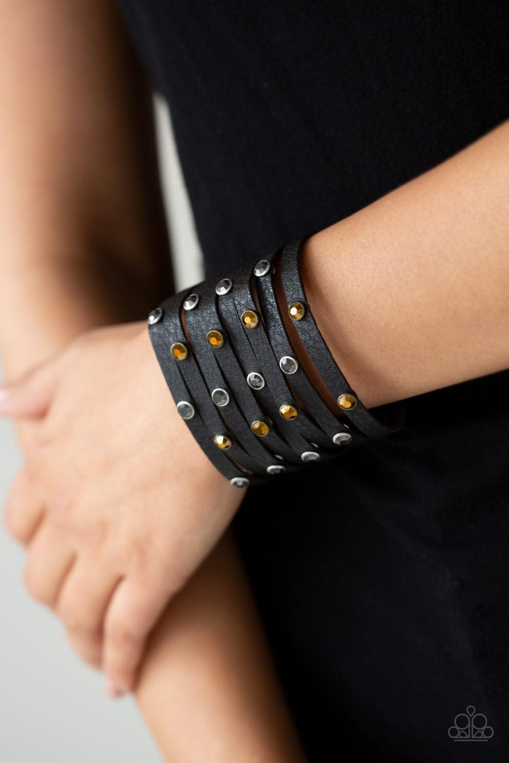Paparazzi Accessories Go-Getter Glamorous - Black Go Getter Glamorous Black – Paparazzi Bracelet. A thick black leather band has been spliced into eight strips across the wrist. Encased in sleek silver fittings, glittery hematite and aurum rhinestones are