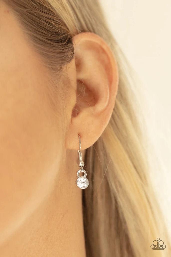 Paparazzi Accessories Gorgeously Glistening - White Encased in sleek silver frames, dainty pairs and trios of glittery white rhinestones delicately link into a timeless display below the collar. Features an adjustable clasp closure. Sold as one individual