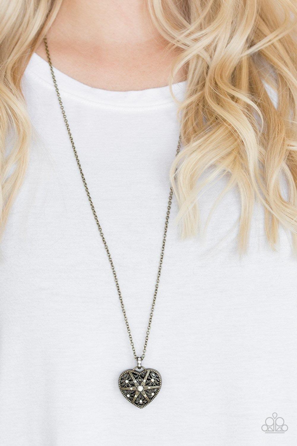 Paparazzi Accessories Casanova Charm ~Brass Encrusted in glittery white rhinestones, a vintage inspired heart pendant swings from the bottom of a shimmery brass chain for a romantic fashion. Features an adjustable clasp closure.