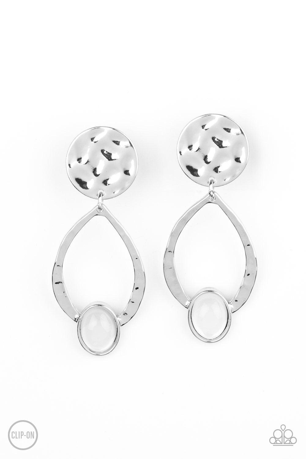 Paparazzi Accessories Opal Obsession - White *Clip-On An opalescent white cat's eye stone dots the bottom of a hammered silver frame that links to a hammered silver disc, coalescing into a dreamy lure. Earring attaches to a standard clip-on fitting. Sold