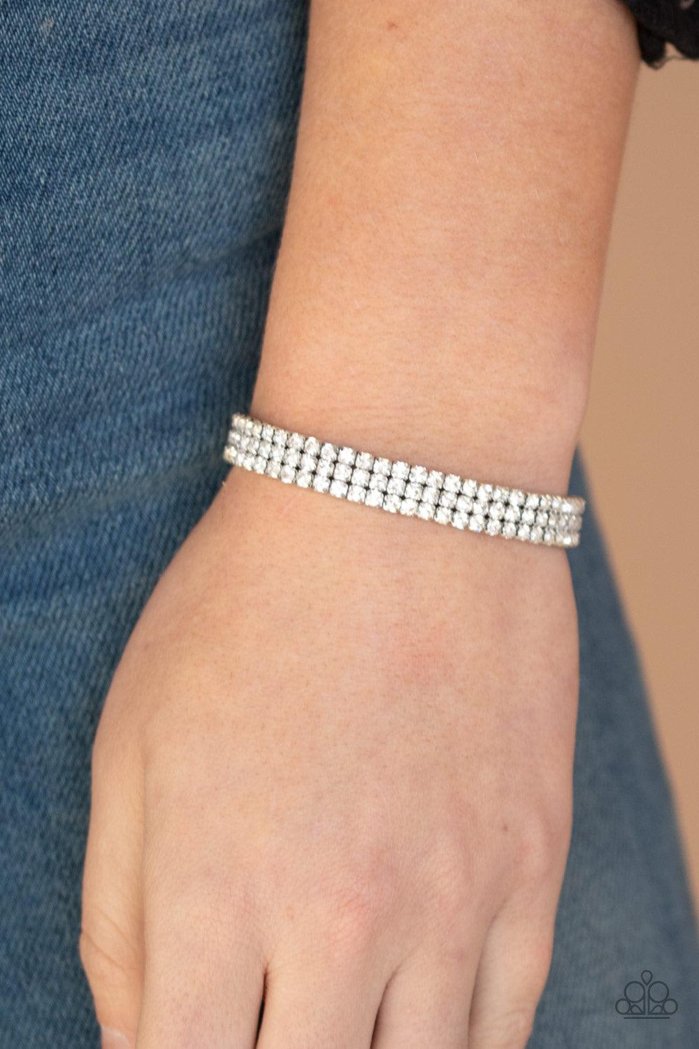 Paparazzi Accessories Stacked Deck - White Featuring sleek silver square fittings, interconnect strands of glittery white rhinestones are threaded along stretchy band around the wrist for a glitzy finish. Jewelry