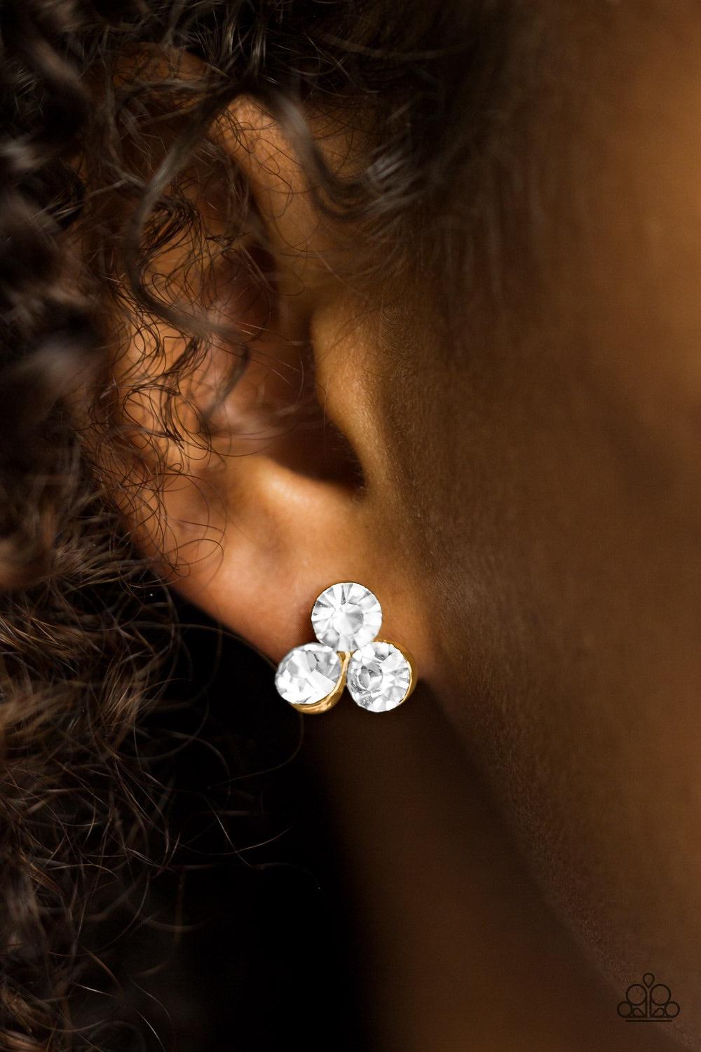 Paparazzi Accessories Everything Must GLOW! - Gold A trio of glowing white rhinestones coalesce into a timeless frame. Earring attaches to a standard post fitting. Jewelry