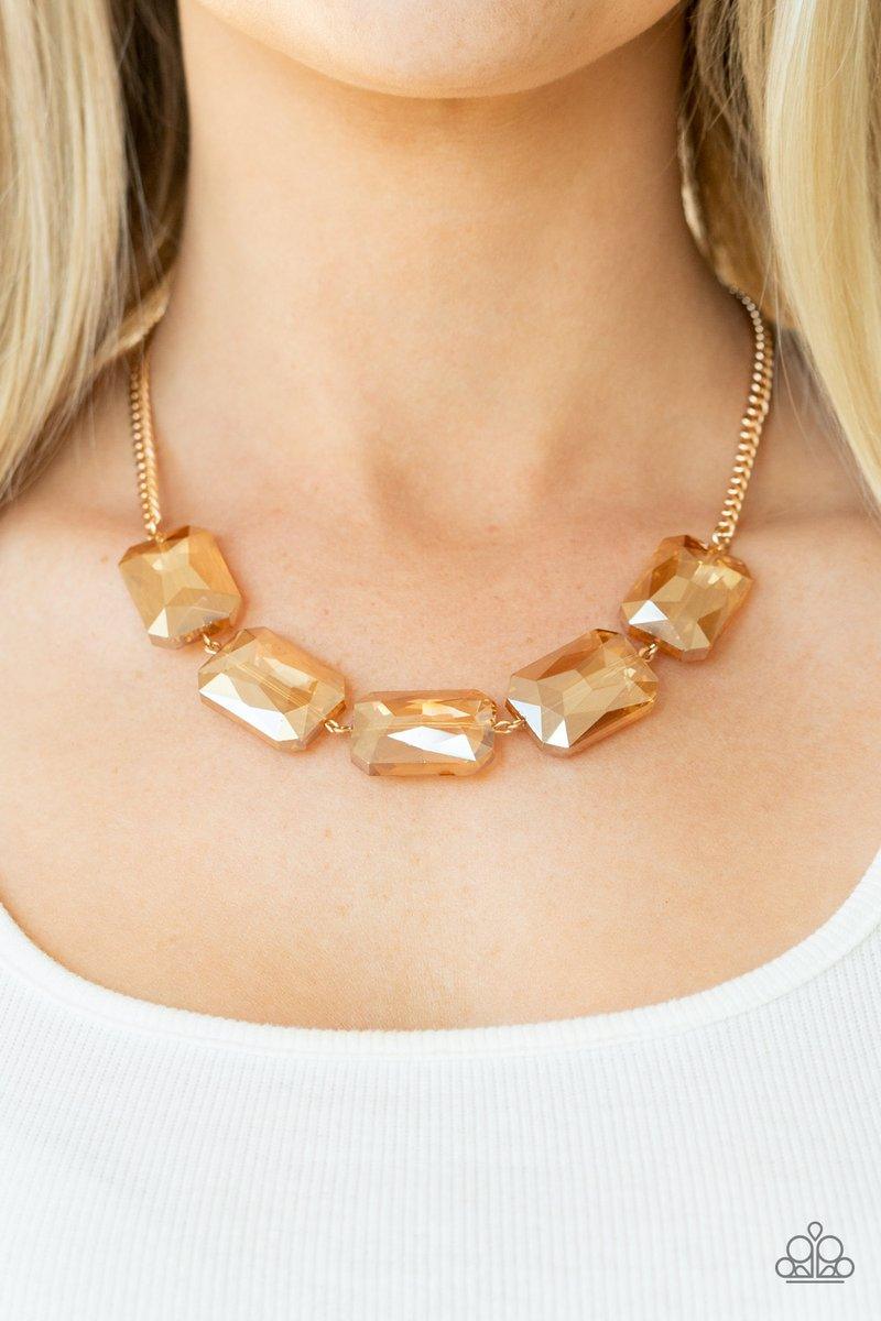 Paparazzi Accessories Heard It On The Heir-Waves ~Gold Gorgeously oversized golden emerald cut gems fabulously link below the collar, creating an iridescently icy statement piece. Features an adjustable clasp closure. Sold as one individual necklace. Incl