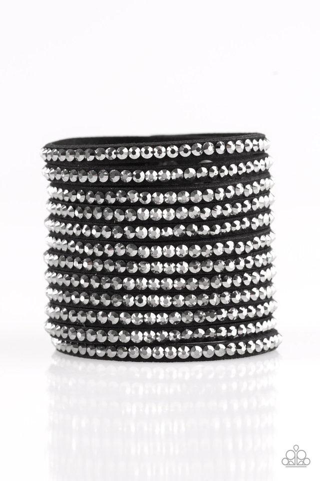 Paparazzi Accessories The Boss Is Back ~Black A thick black suede band is spliced into various strands. Glassy hematite rhinestones are sprinkled across the strands, creating blinding shimmer around the wrist for a knockout look. Features an adjustable sn