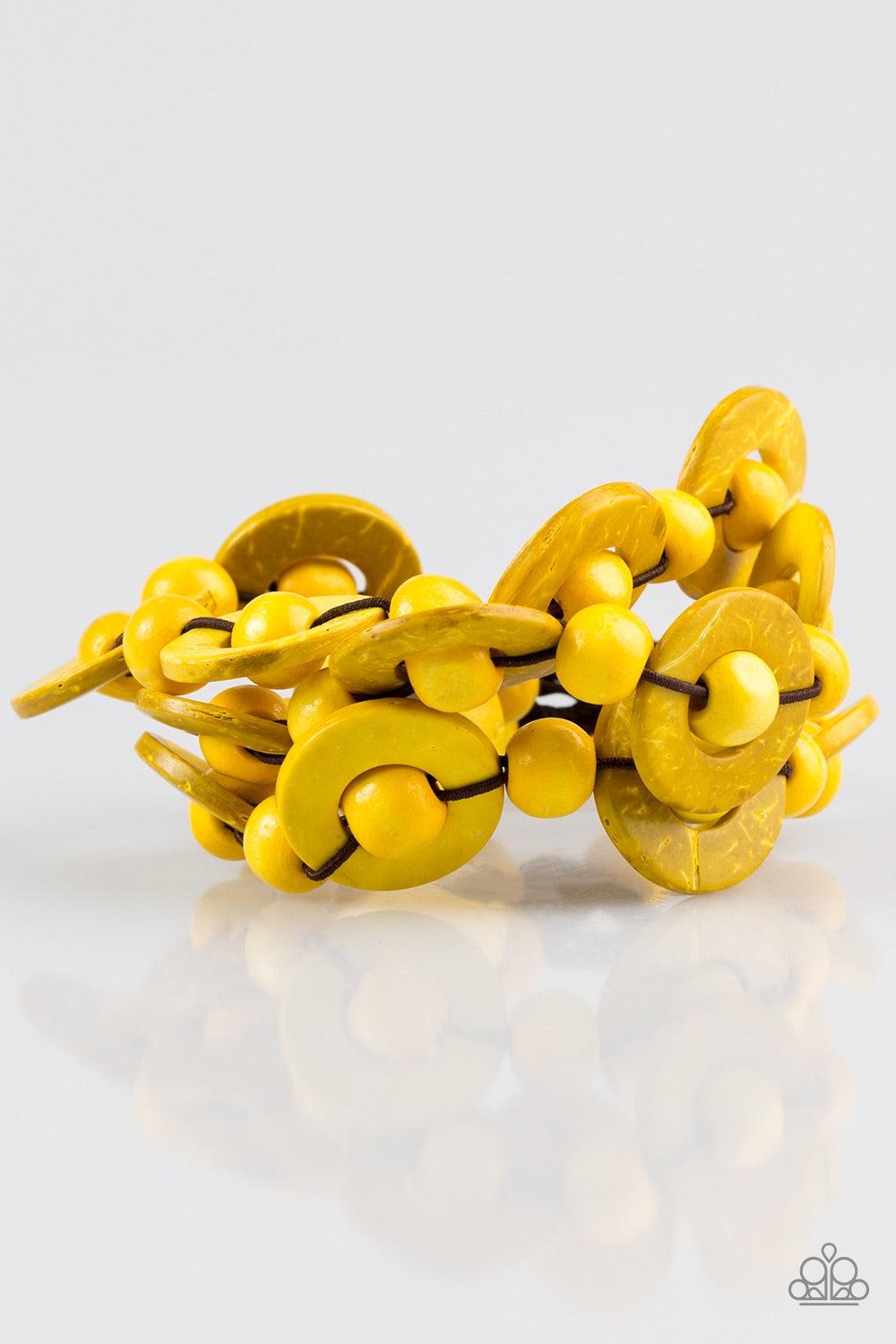 Paparazzi Accessories Cancun Catch ~Yellow Brushed in sunny yellow finishes, wooden rings and beads are knotted in place along three stretchy strands, creating summery layers around the wrist. Features a button loop closure.