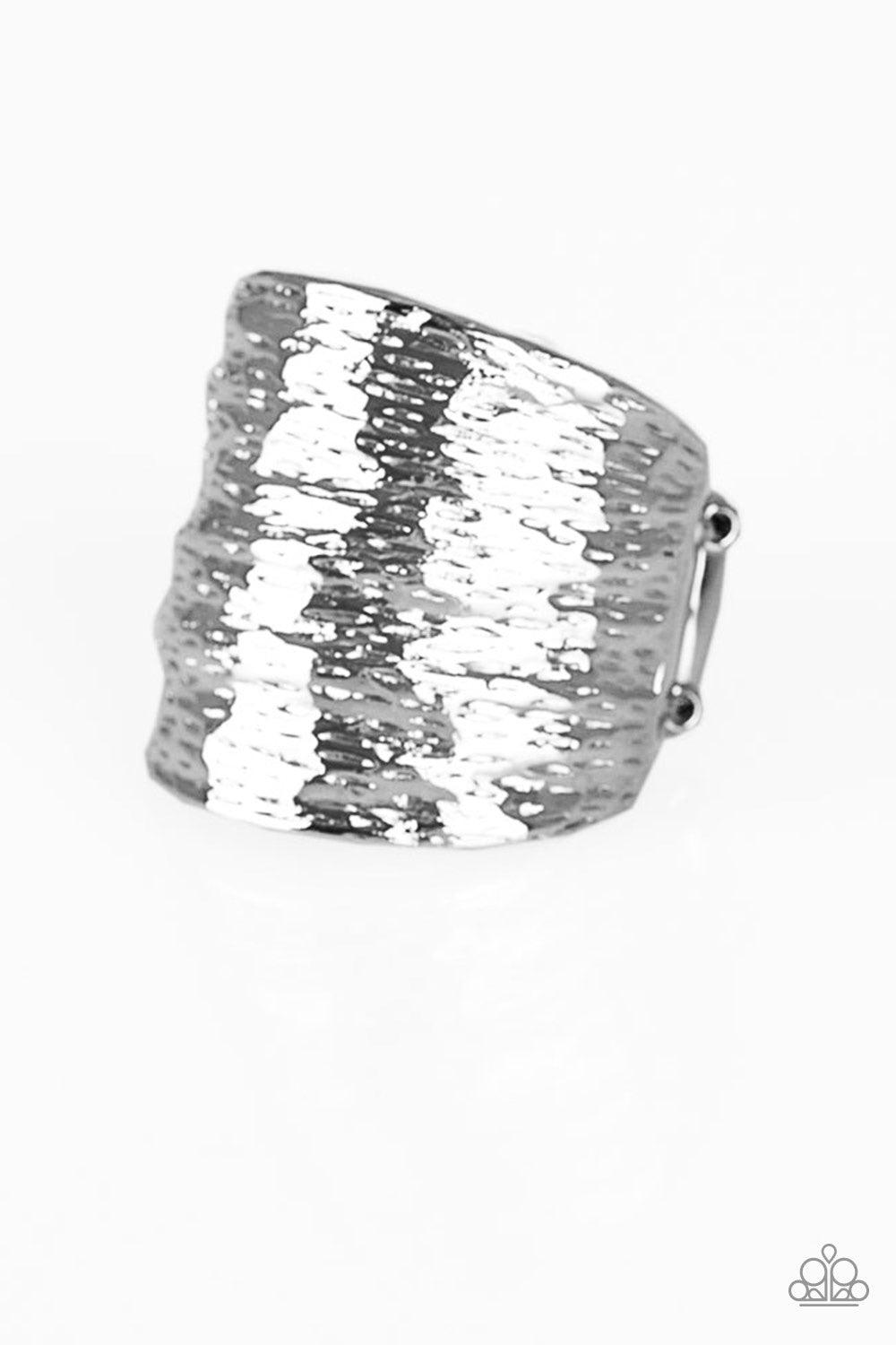 Paparazzi Accessories Paleo Patternu - Silver Radiating with patterns derived from nature, a rippling silver frame curves around the finger for a bold look. Features a stretchy band for a flexible fit. Jewelry