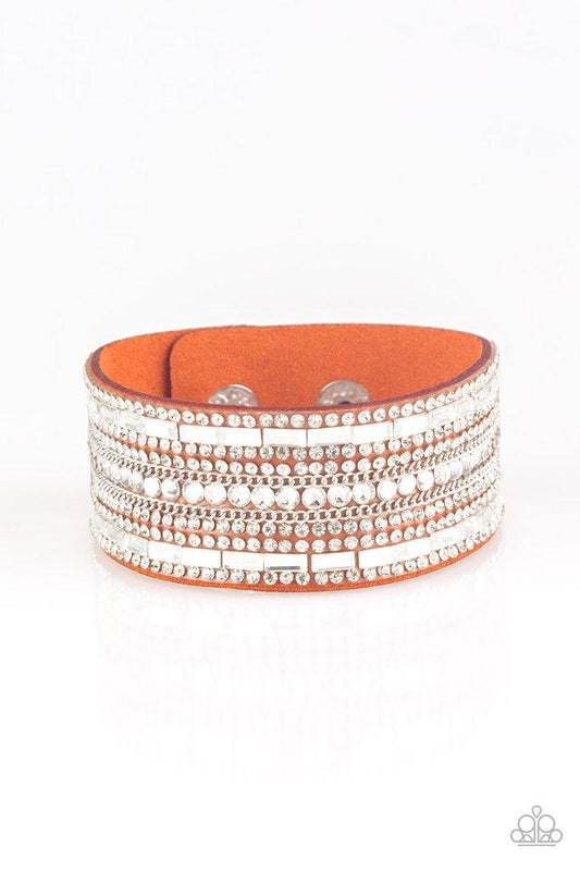 Paparazzi Accessories Rebel Radiance - Orange Featuring classic round and edgy emerald style cuts, glittery white rhinestones and glistening silver chains are encrusted along bands of orange suede for a sassy look. Features an adjustable snap closure. Jew