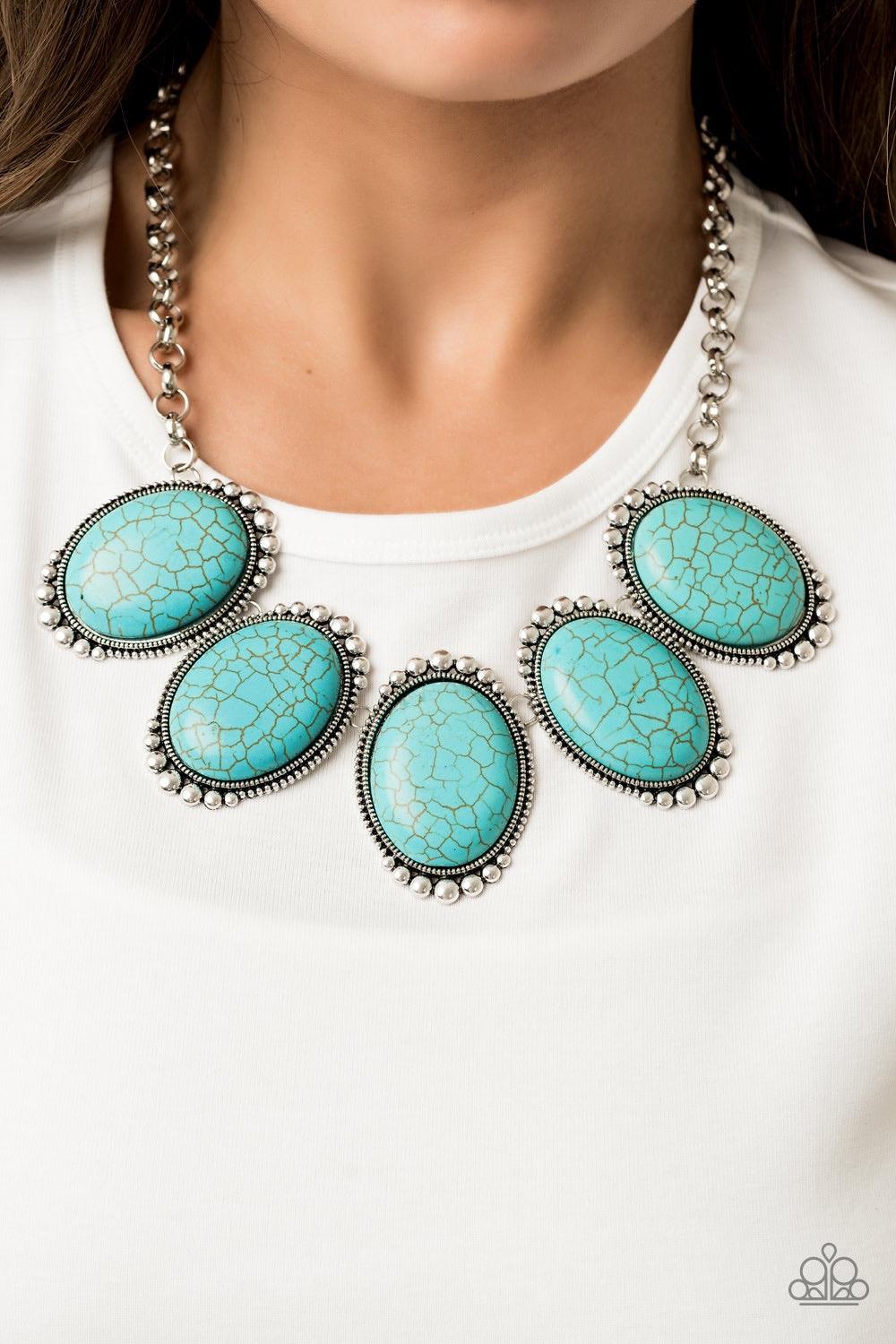 Paparazzi Accessories Prairie Goddess - Blue Chiseled into tranquil ovals, oversized turquoise stones are pressed into antiqued silver frames radiating with studded textures. The refreshing frames delicately link below the collar for a statement-making fi