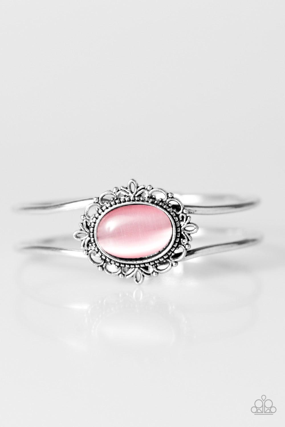 Paparazzi Accessories Castles And Champions - Pink A glassy pink moonstone is pressed into a frilly silver frame, creating a whimsical center piece. The bangle-like bars curl around the wrist, creating an airy piece. Features an adjustable hinged clasp. J