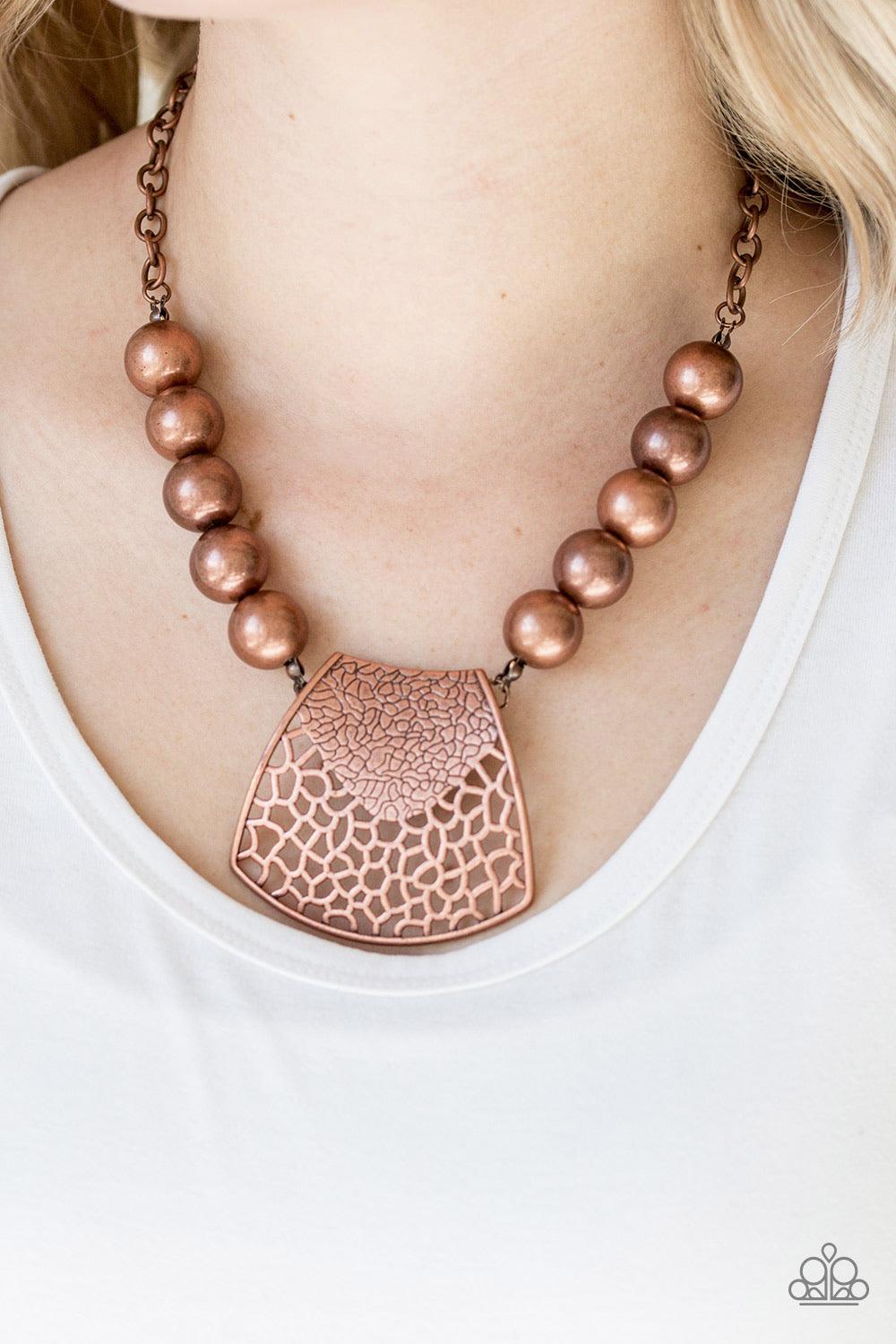 Paparazzi Accessories Large And In Charge - Copper Featuring ornately stenciled and embossed details, a flared copper plate swings from a boldly copper beaded chain below the collar for a fierce look. Features an adjustable clasp closure. Jewelry