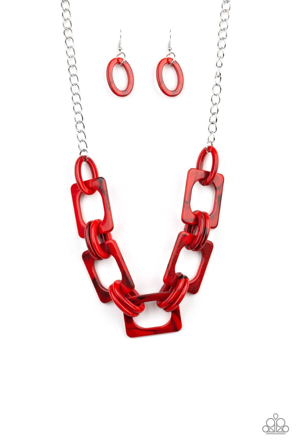 Paparazzi Accessories Sizzle Sizzle - Red Suspended from a shimmery silver chain, a collision of round and square red acrylic links connect below the collar in a statement-making fashion. Features an adjustable clasp closure. Jewelry