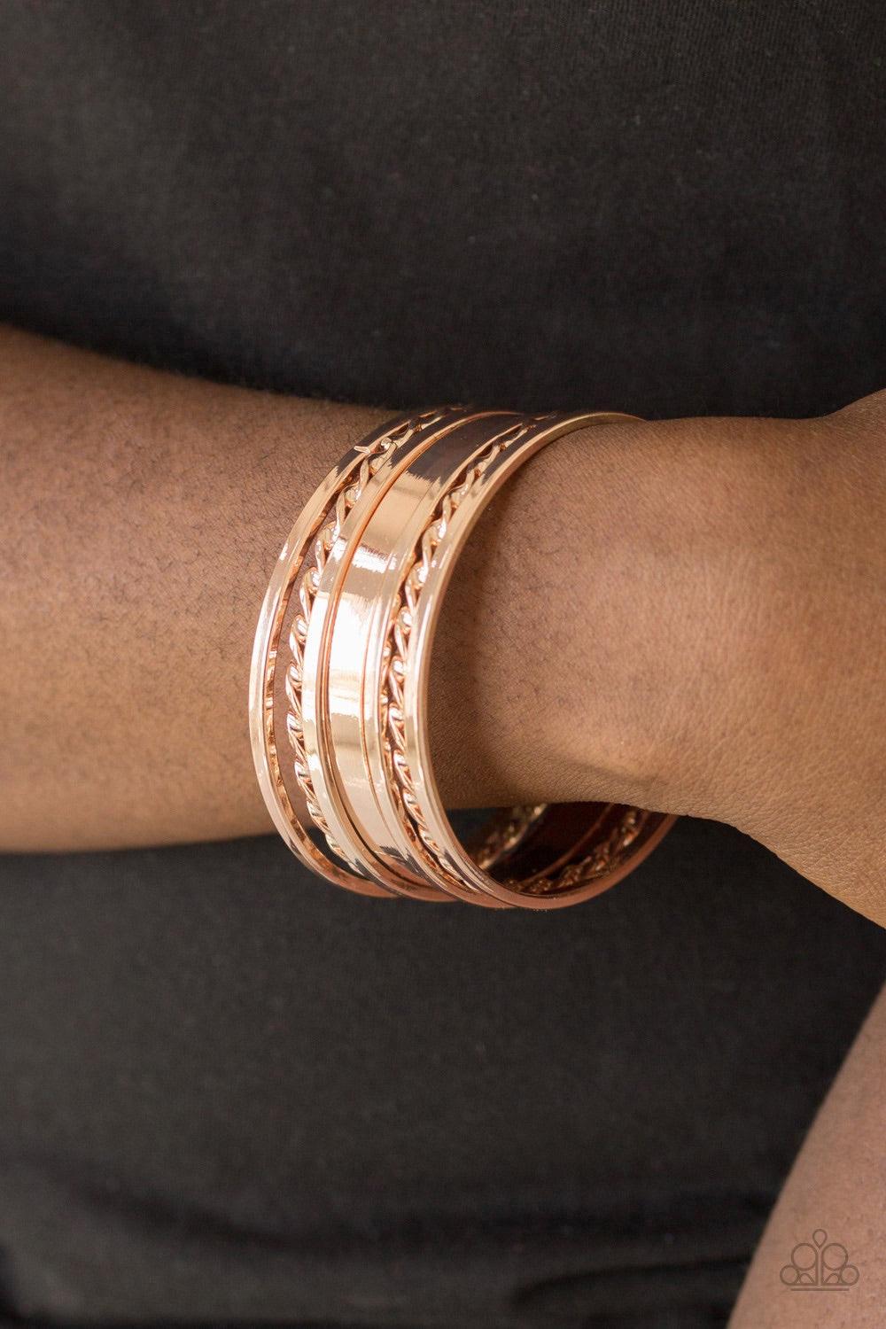 Paparazzi Accessories Basic Blend - Rose Gold Featuring smooth and twisted surfaces, mismatched rose gold bangles stack across the wrist for a casual look. Jewelry