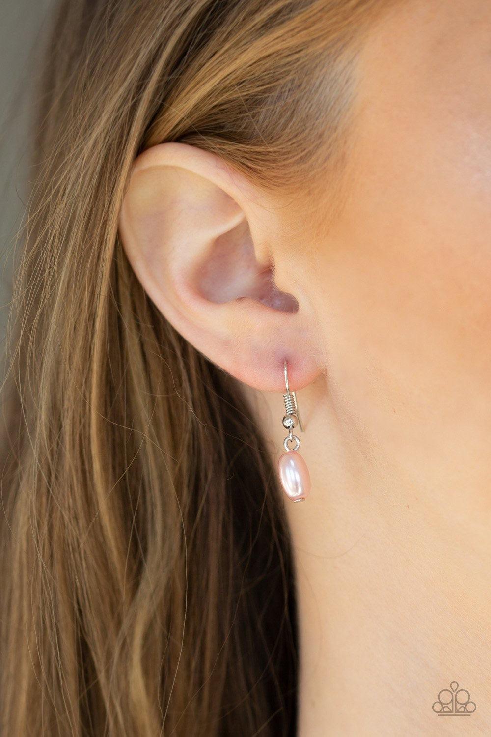 Paparazzi Accessories Pacific Pageantry - Pink An elegant collection of pearly pink, dainty silver, and pink crystal-like beads are fitted in place along three silver wires below the collar, creating the illusion of floating layers. Features an adjustable
