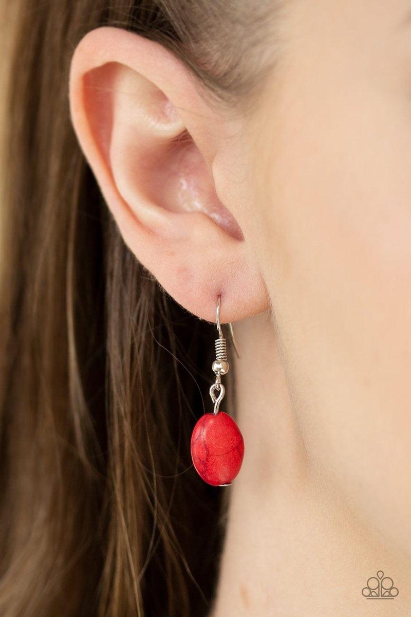 Paparazzi Accessories Grounded in ARTIFACT - Red Glistening silver chains drape across the chest, creating four shimmery layers. A dainty silver disc swings from the uppermost layer above a fiery red stone, ornate triangular frame, and hammered silver arr