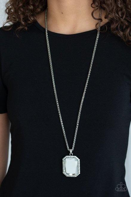 Paparazzi Accessories Let Your HEIR Down - White Bordered in dainty white rhinestones, an oversized faceted white emerald style gem swings from the bottom of an antiqued silver wheat chain for a blinding look. Features an adjustable clasp closure. Jewelry