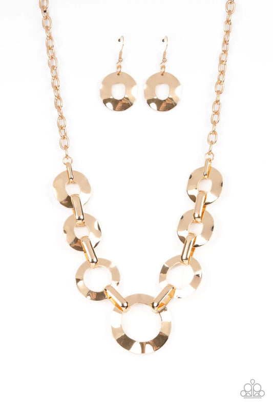 Paparazzi Accessories Mechanical Masterpiece - Gold Featuring hammered surfaces, crinkled gold rings gradually increase in size as they alternate with bold gold fittings below the collar for an intense industrial fashion. Features an adjustable clasp clos