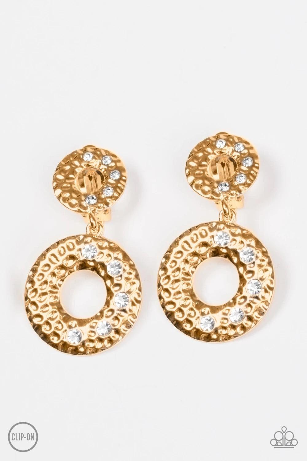 Paparazzi Accessories Sophisticated Shimmer - Gold Hammered in glistening textures, a circular gold frame gives way to a slightly larger gold frame, creating an elegant lure. Dainty white rhinestones are sprinkled across the frames, adding a glittery fini