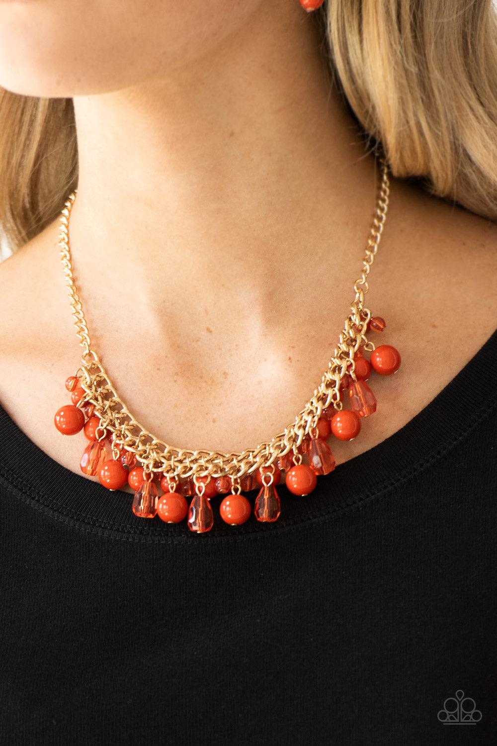 Paparazzi Accessories Tour De Trendsetter - Orange Varying in shape, glassy and polished orange beads swing from the bottom of interlocking gold chains. Crystal-like teardrops are sprinkled along the colorful beading, creating a flirtatious fringe below t