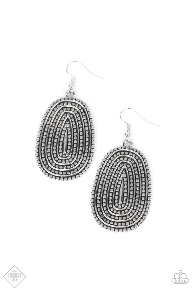 Paparazzi Accessories Desert Climate - Silver Rows of antiqued silver dotted texture radiate outward from an embossed center. The concentric lines create a rippling effect across the frame resulting in a rustic finish. Earring attaches to a standard fishh