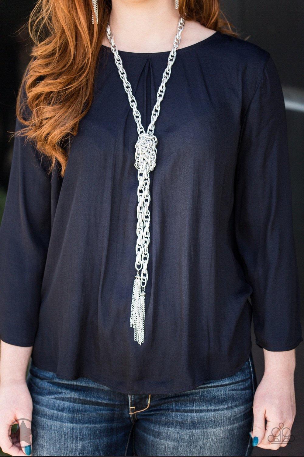 Paparazzi Accessories SCARFed for Attention - Silver A single strand of spiraling, interlocking links with light-catching texture is anchored by two tassels of chain that add dramatic length to the piece. Undeniably the most versatile piece in Paparazzi's