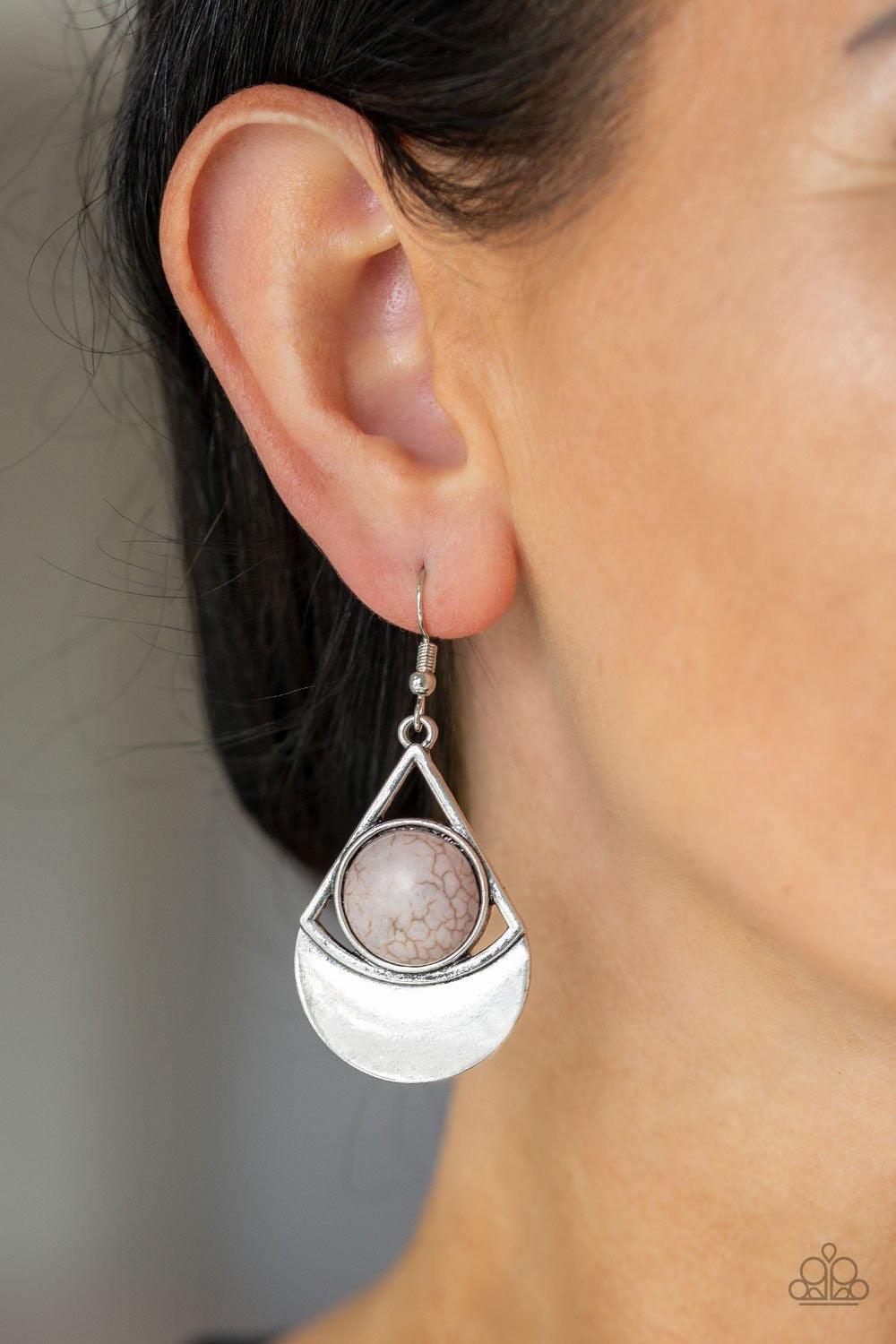 Paparazzi Accessories Sonoran Sailing - Silver Brushed in an antiqued finish, a glistening triangular frame attaches to a shimmery silver crescent frame. A round gray stone is pressed into the center of the geometric frame for a seasonal flair. Earring at