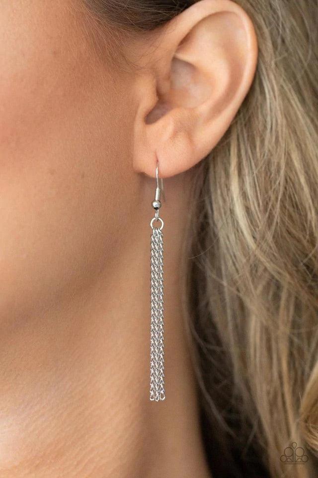 Paparazzi Accessories One Night In Casablanca - Green Flecked in glittery green sparkles, a scalloped cork frame is pressed into a sleek silver frame at the bottom of a dainty silver satellite chain. A classic silver chain tassel swings from the whimsical