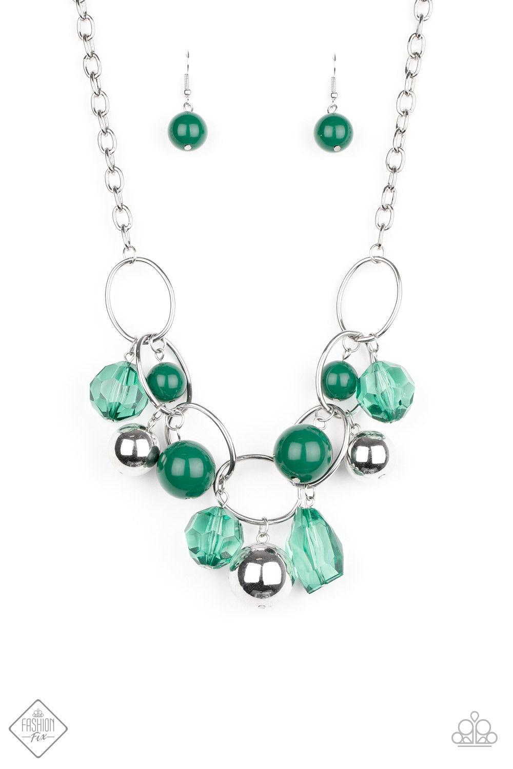 Paparazzi Accessories Cosmic Getaway - Green Infused with faceted Ultramarine Green crystal-like beads, a bubbly collection of oversized silver and Ultramarine Green beads swing from the bottom of an interconnected row of bold silver oval frames, creating