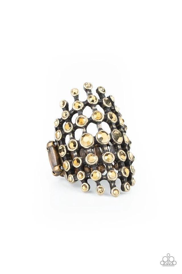 Paparazzi Accessories Fiercely Flashy - Brass Featuring glistening brass fittings, a sparkly series of aurum rhinestones interlock into an edgy grid across the finger for a spellbinding look. Features a stretchy band for a flexible fit. Jewelry