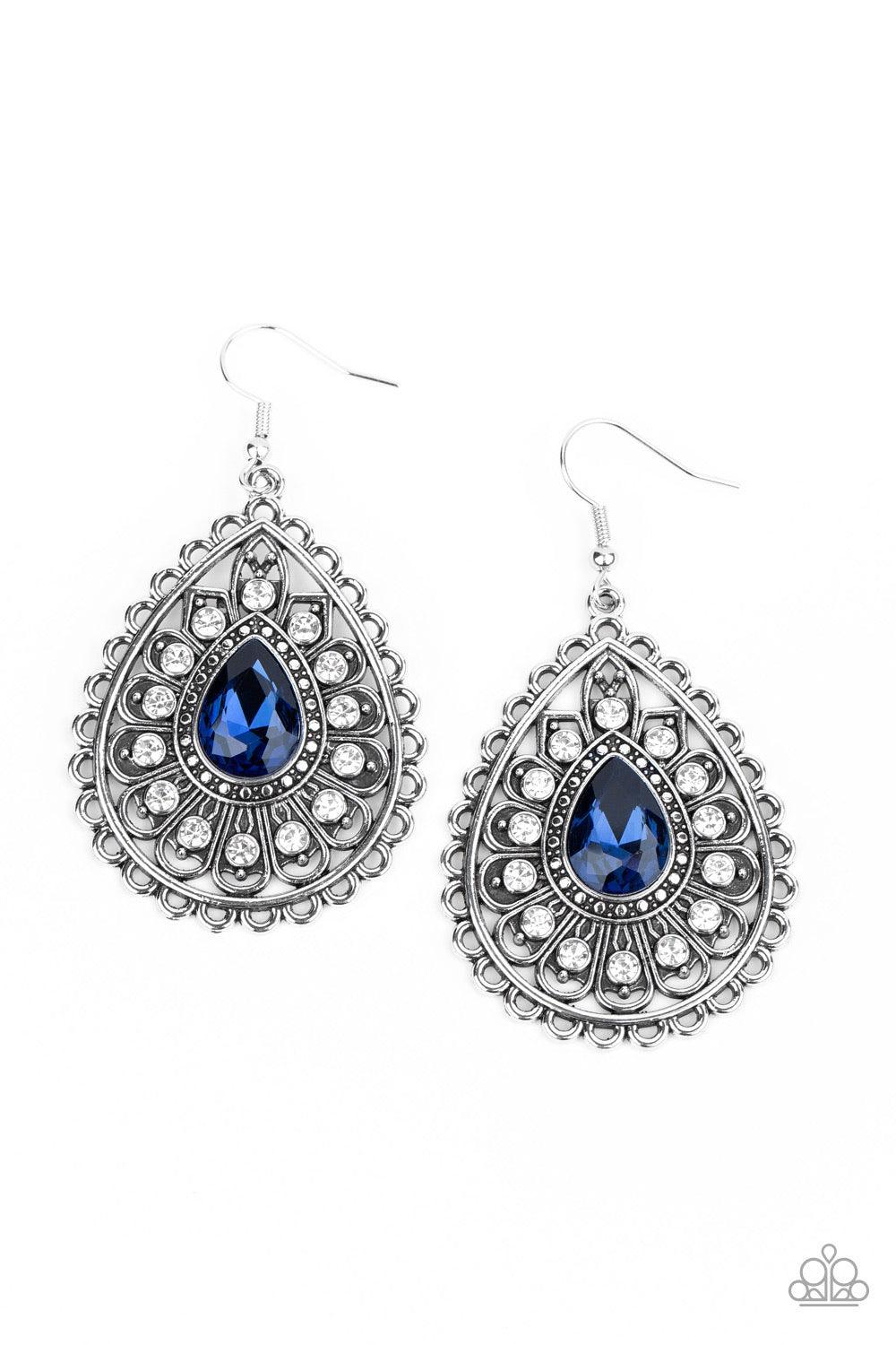 Paparazzi Accessories Eat, Drink, and BEAM Merry - Blue White rhinestone dotted silver petals flare out from a blue teardrop rhinestone center, coalescing into a frilly frame. Earring attaches to a standard fishhook fitting. Sold as one pair of earrings.